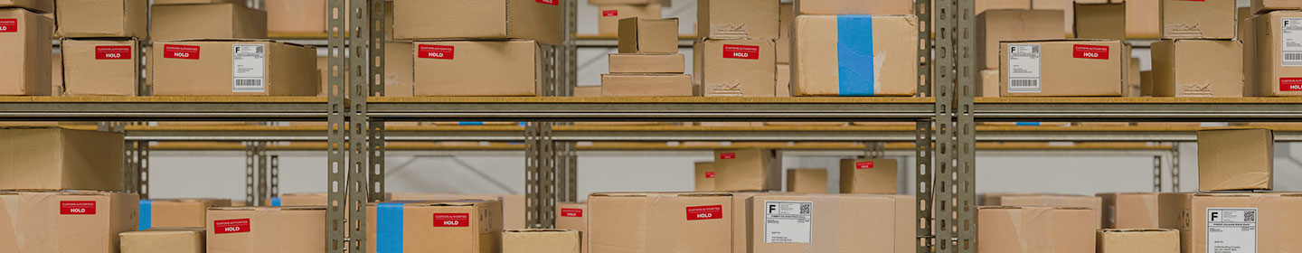 shelves full of packages with yellow banner saying Custom Control Zone